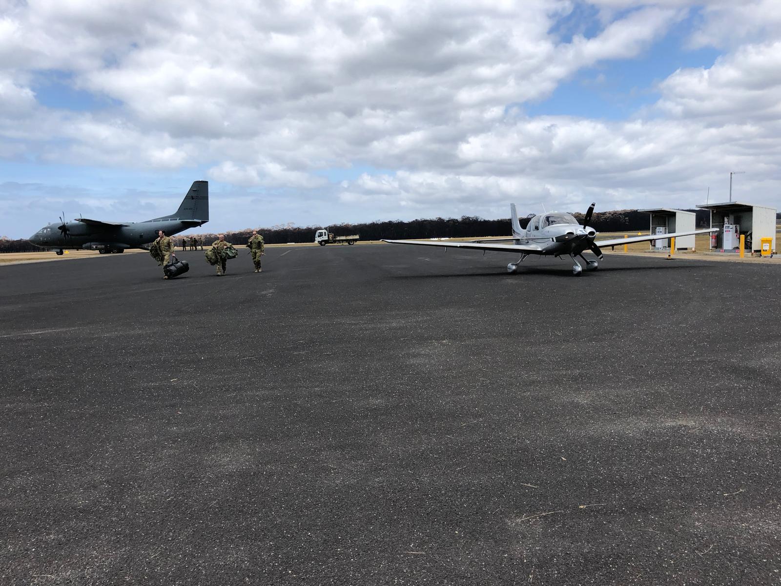 Dr Adam Hill's Cirrus SR22 parked next to an Australian Defence Force C-27J Spartan at Mallacoota airport during the Black Summer bushfires